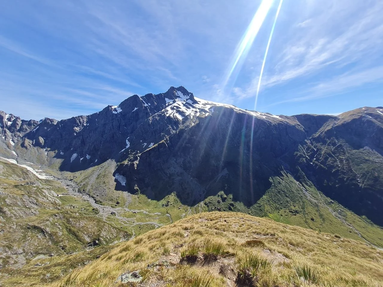 Alpine terrain near Gillespie Pass, rugged rock and snow patches, two figures on the ridge.