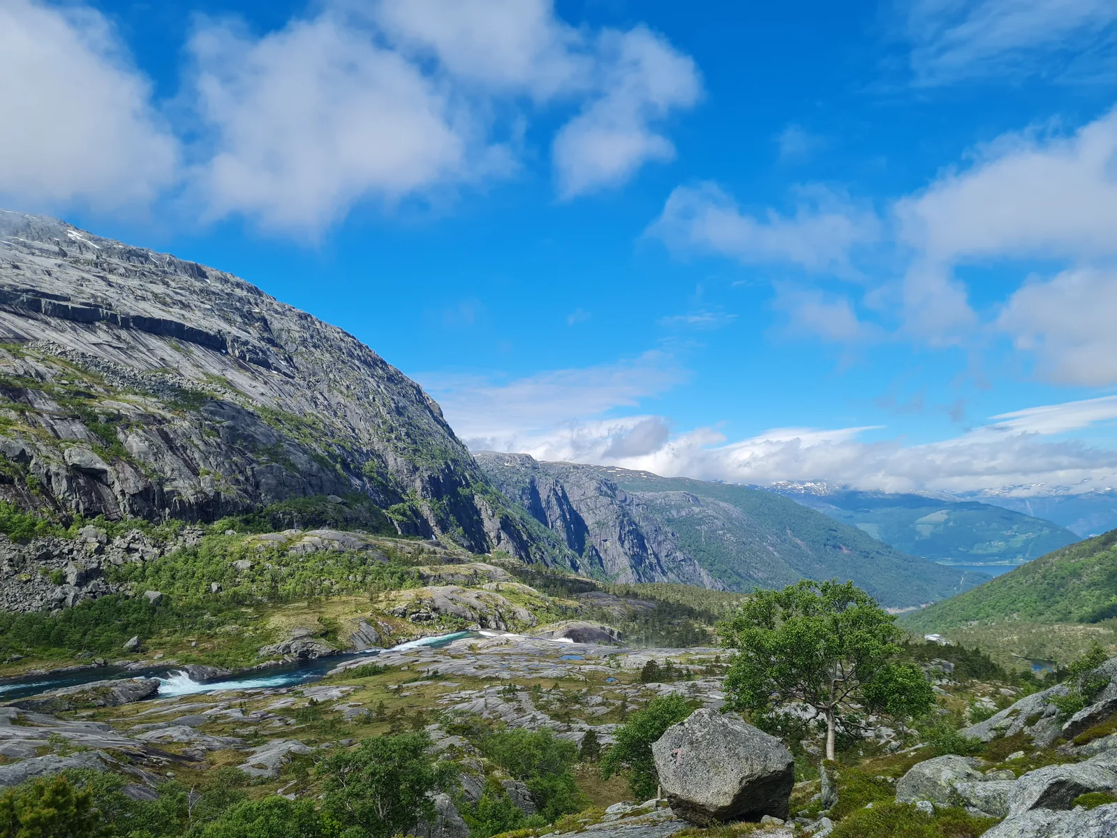 Broad granite slabs and the surging Kinso river flowing through the lower canyon towards Kinsarvik.
