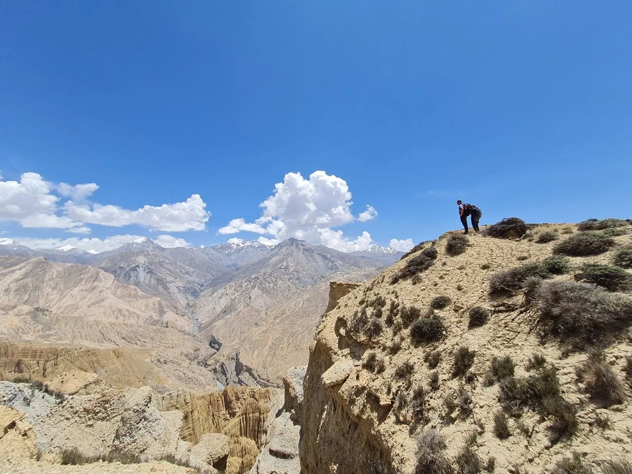 Hiker surveys the arid canyon landscape on the Mustang circuit, Nepal.