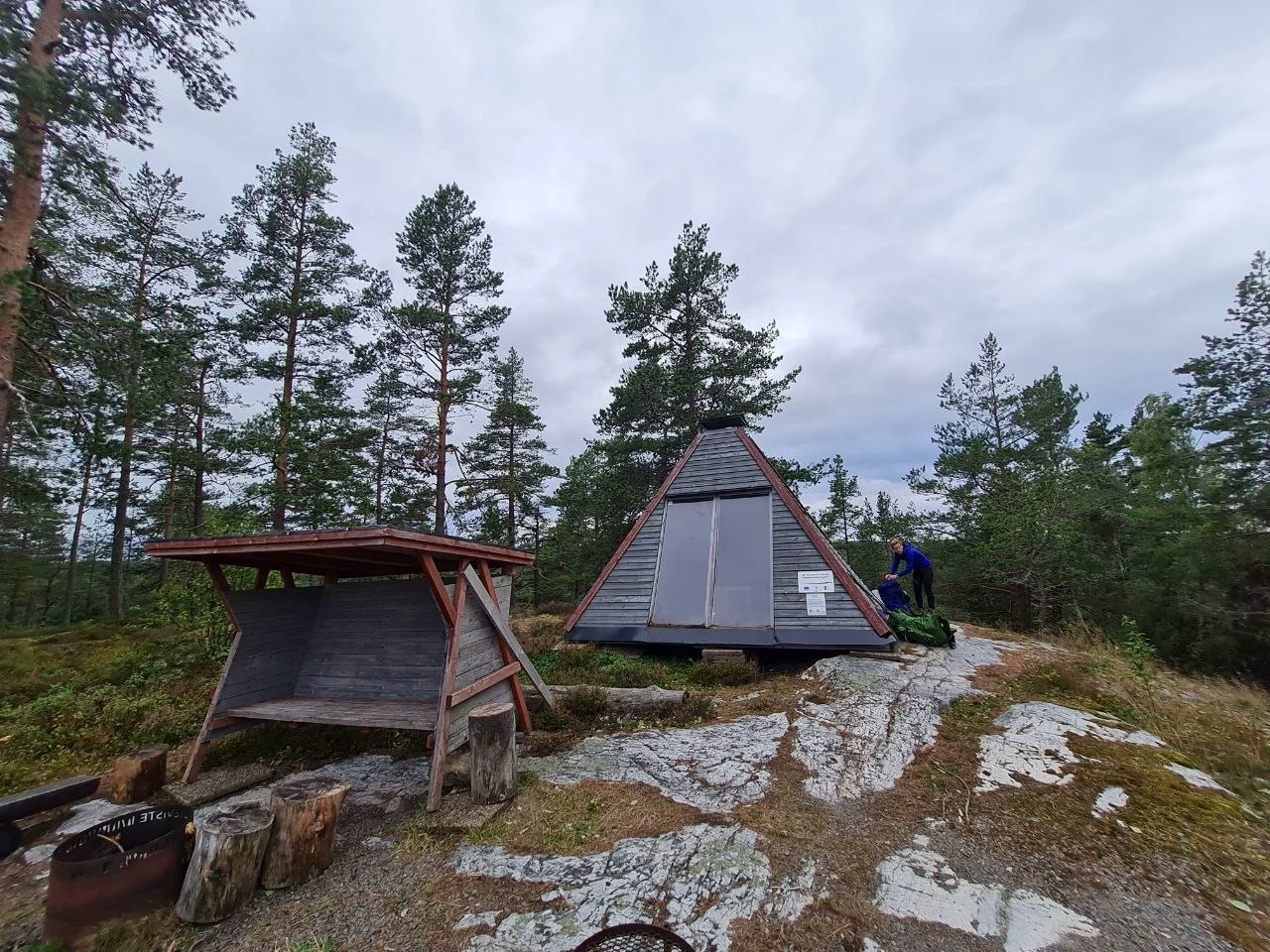 Wooden wind shelter with fire pit