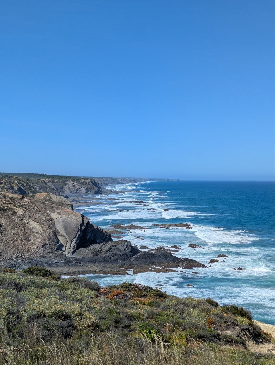 Rocky coastline and waves along Rota Vicentina trail
