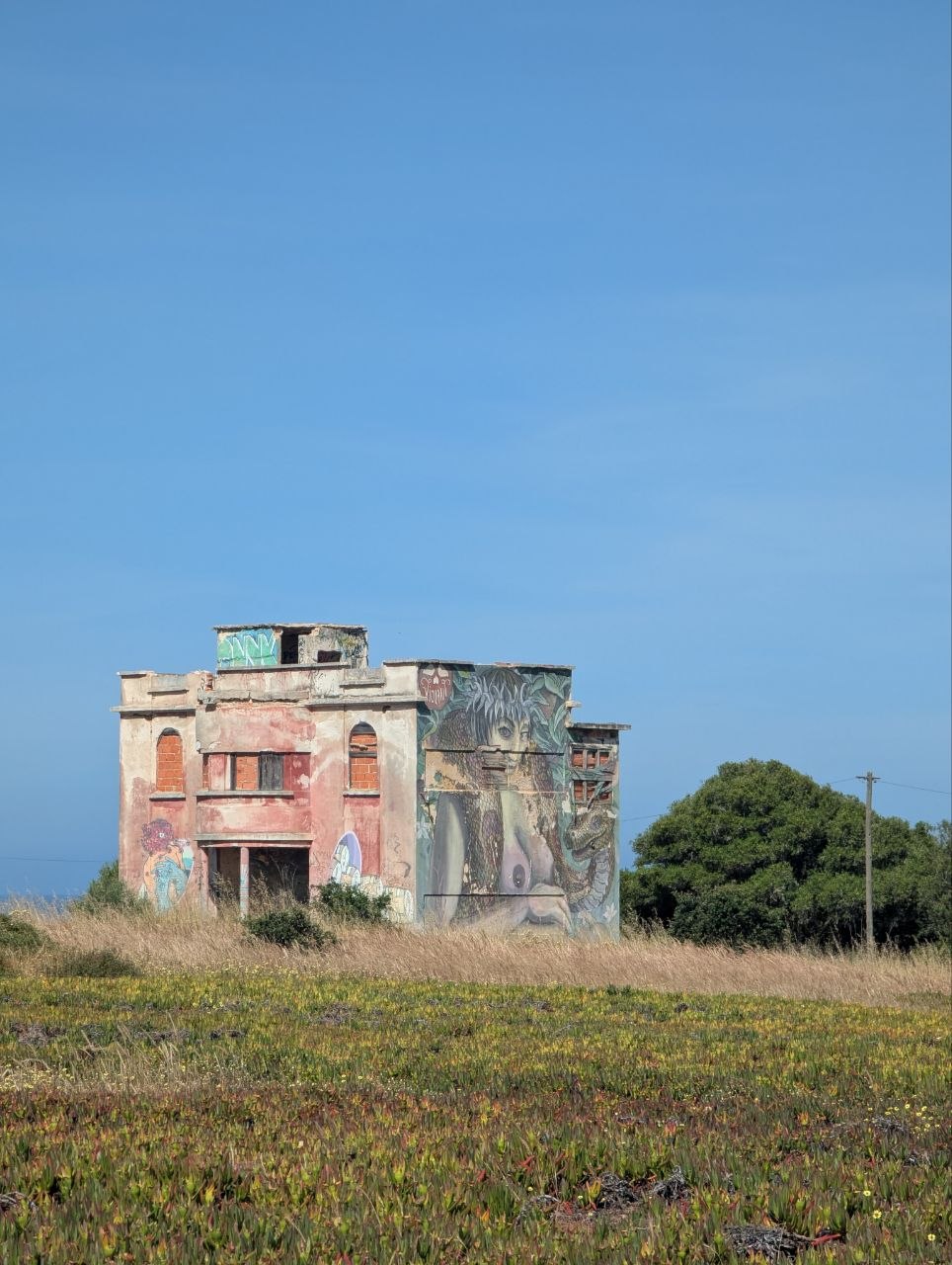 Abandoned building with colorful graffiti near the coast