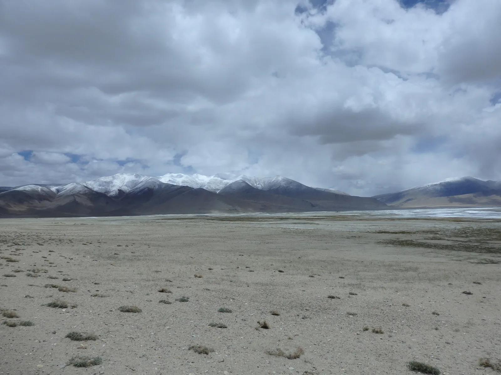 White salt crusts and brackish wetlands lining the shores of Lake Tso Kar.