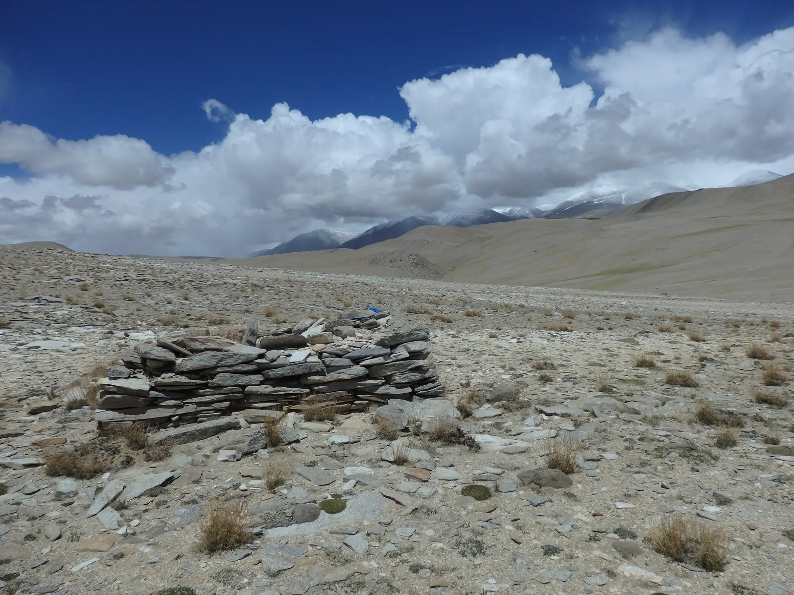 Ancient Buddhist Mani wall carved with sacred Tibetan mantras overlooking the Changthang.